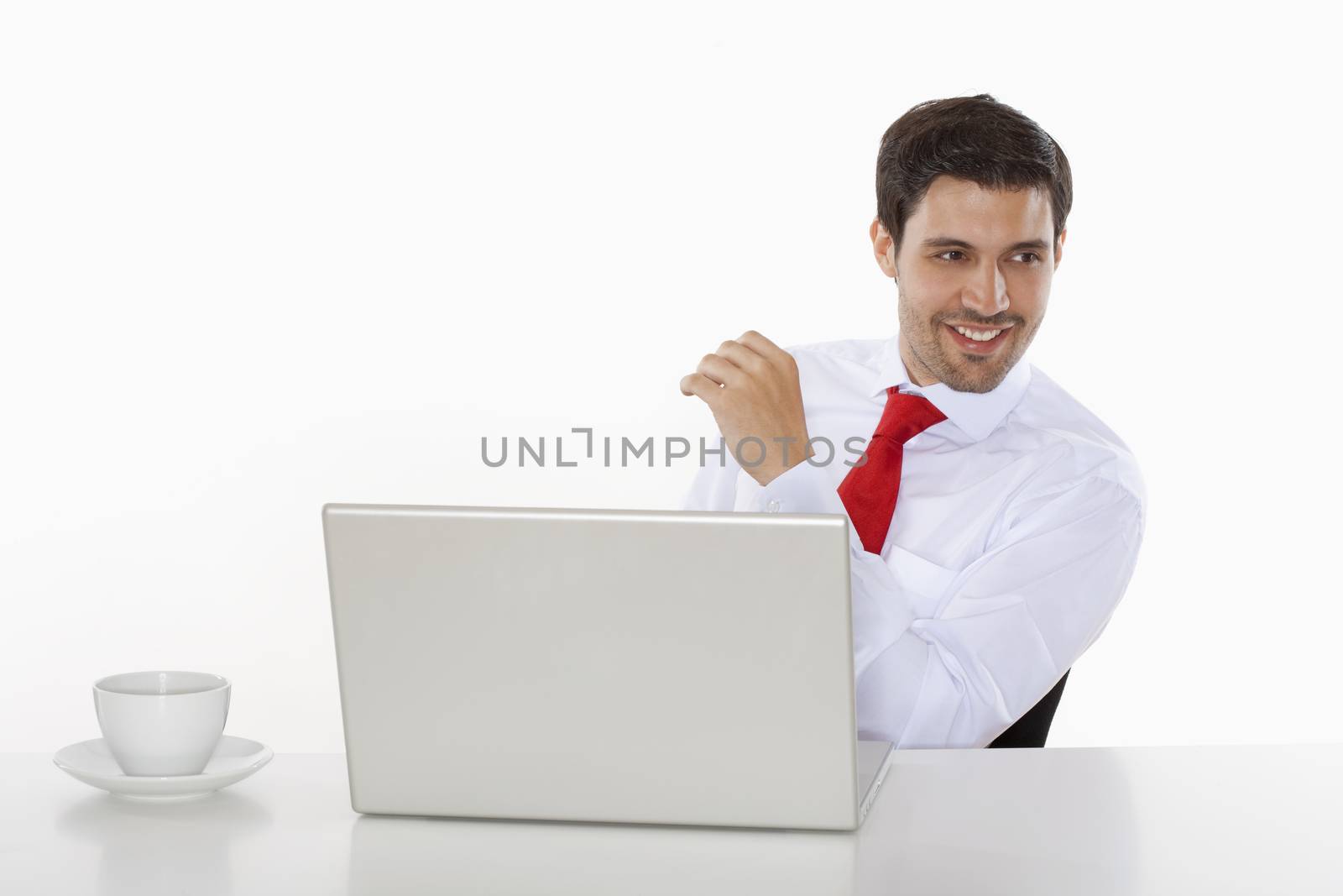 young business executive in white shirt behind desk with laptop