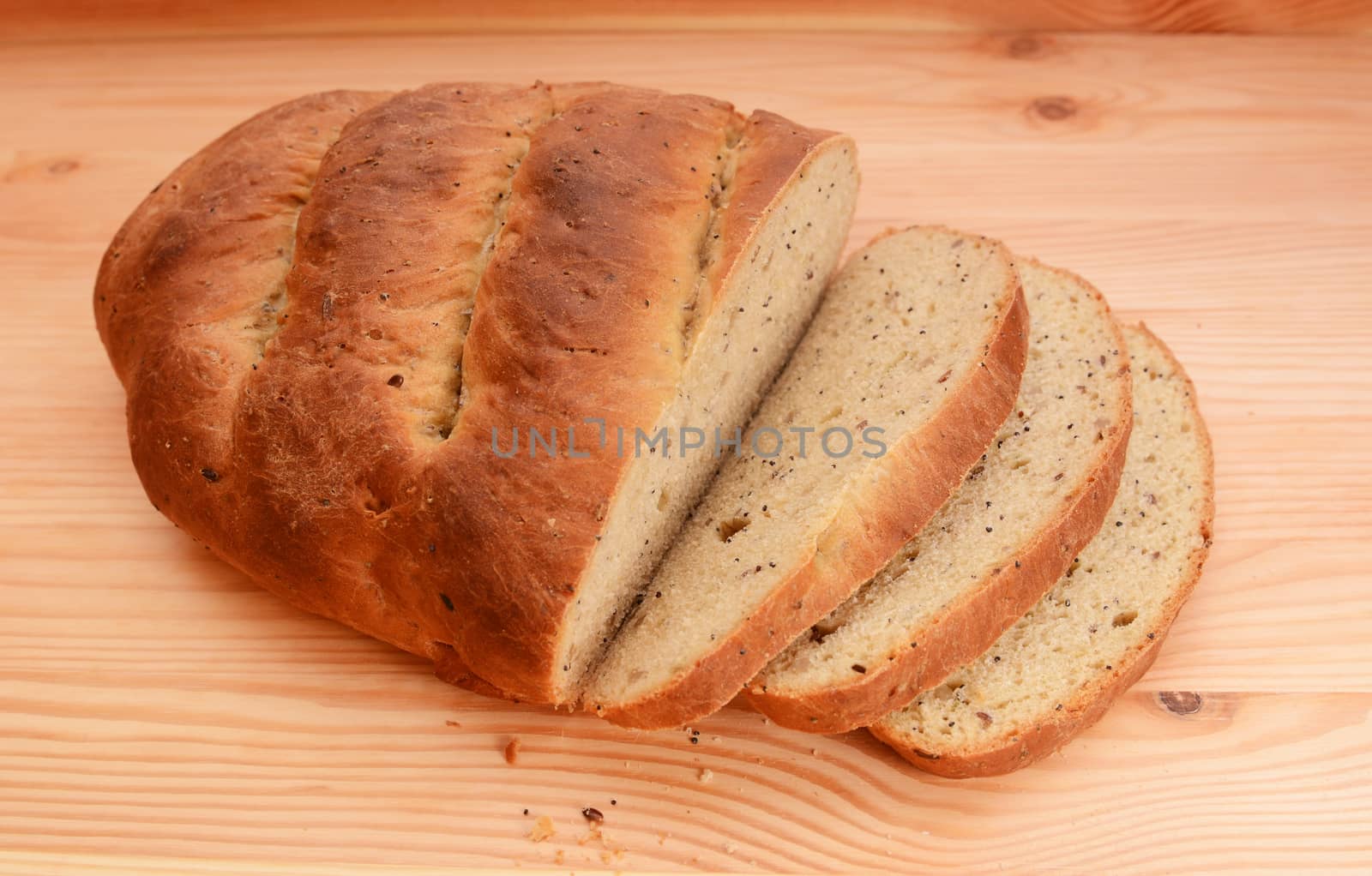 Freshly cut slices of seeded bread fanned out from a new loaf