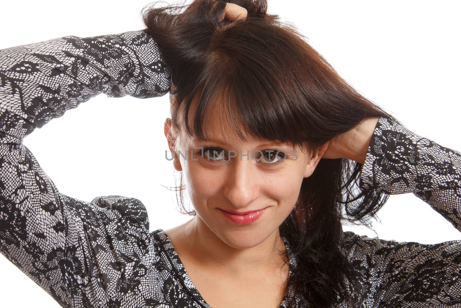 An adult brunette doing her brown hair