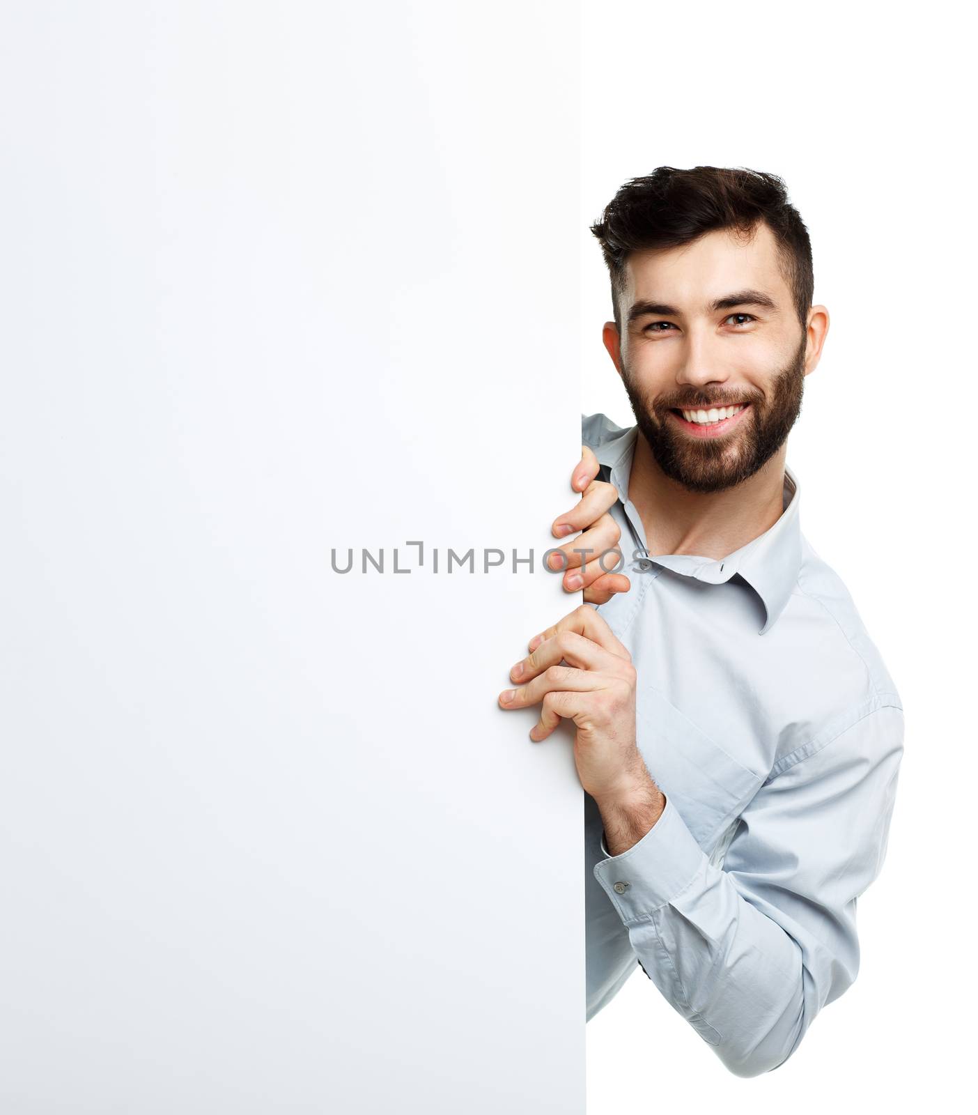 A young bearded man showing blank signboard, isolated over white background