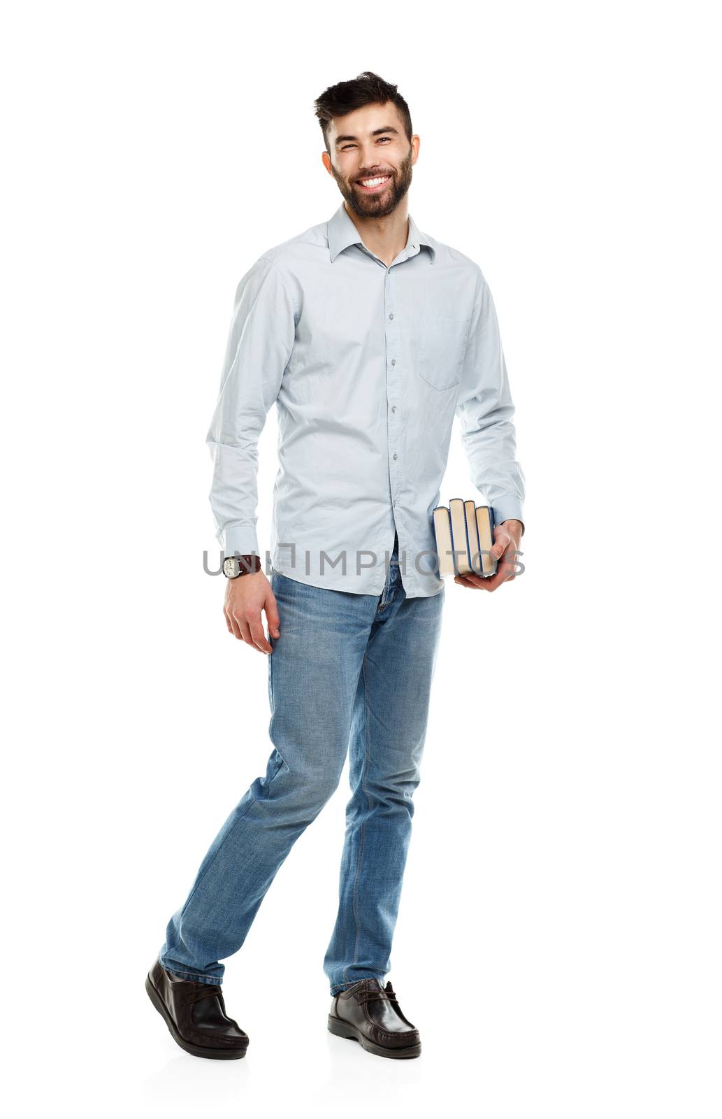 Young bearded smiling man with books in hand on white background