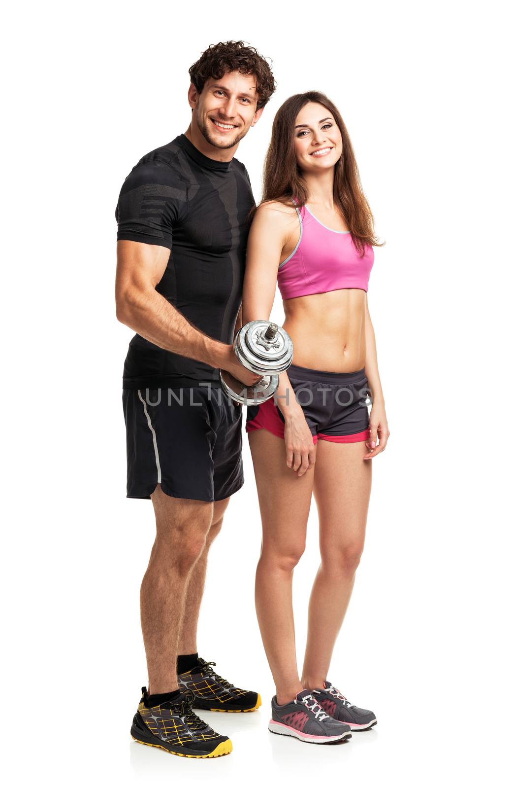Athletic man and woman with dumbbells on the white by vlad_star