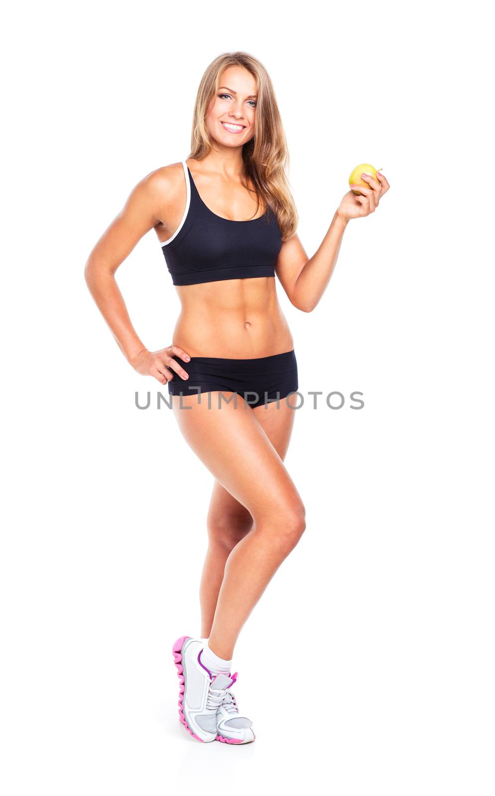 Young smiling girl holding green apple in hand. Fitness woman isolated on white background