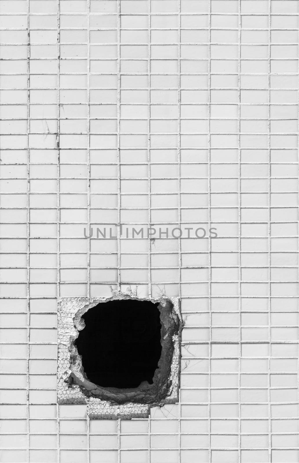 Hole on the old white wall. Picture can be used as a background