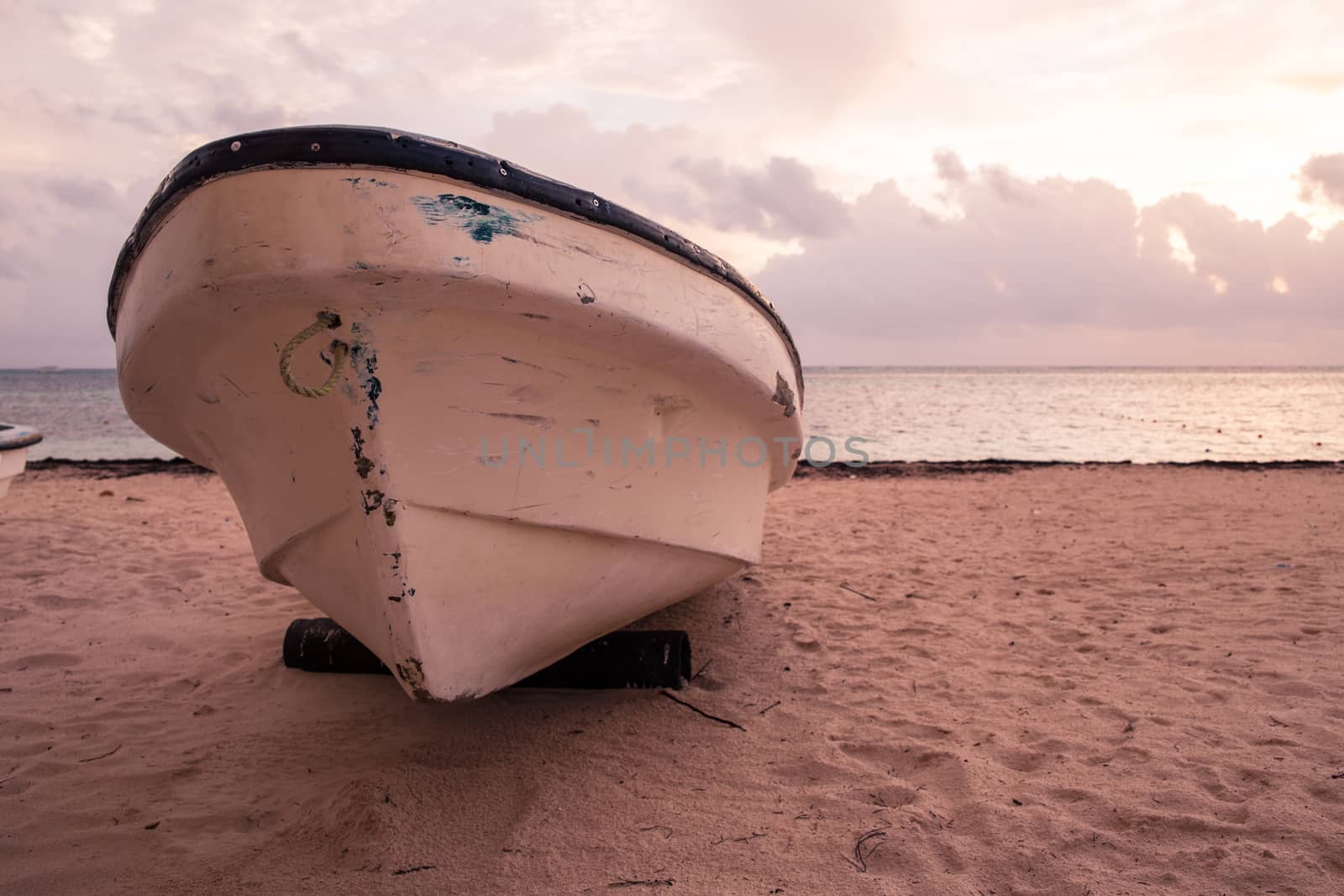 Boat on sandy Tropical Caribbean beach