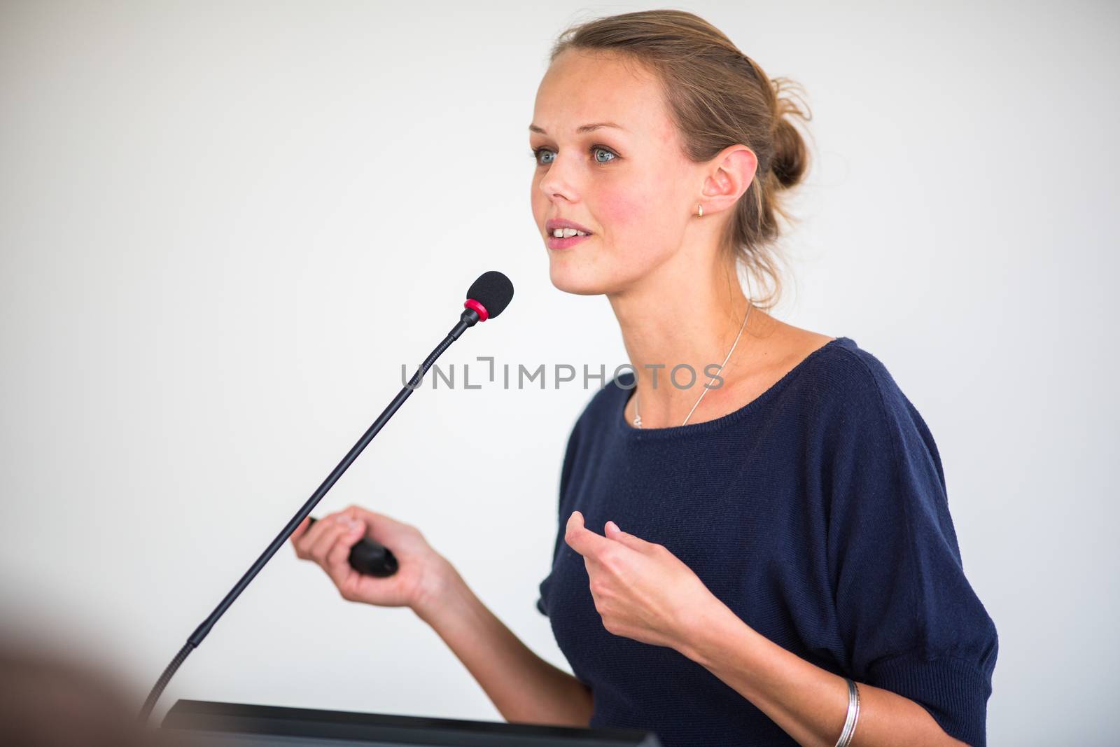 Pretty, young business woman giving a presentation by viktor_cap