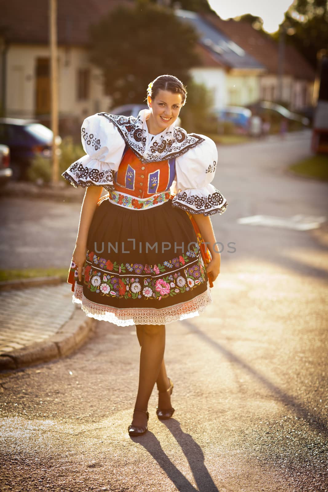 Keeping tradition alive: young woman in a richly decorated ceremonial folk dress/regional costume (Kyjov folk costume, Southern Moravia, Czech Republic)