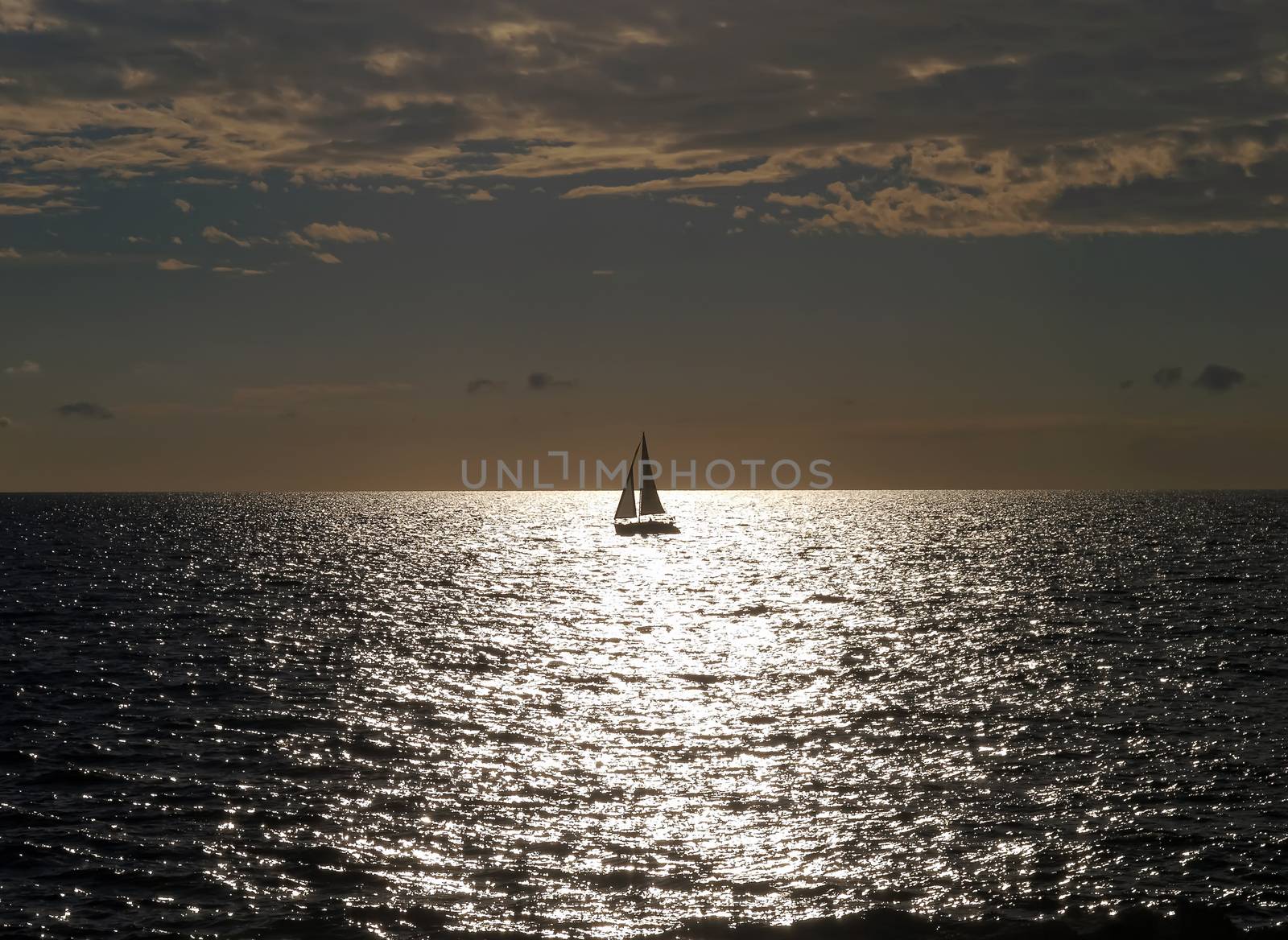summer sundown and sailboat on the ocean