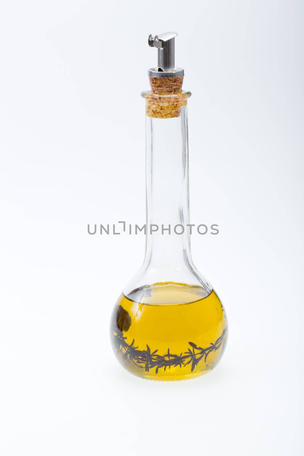 Thyme infused olive oil over white background 