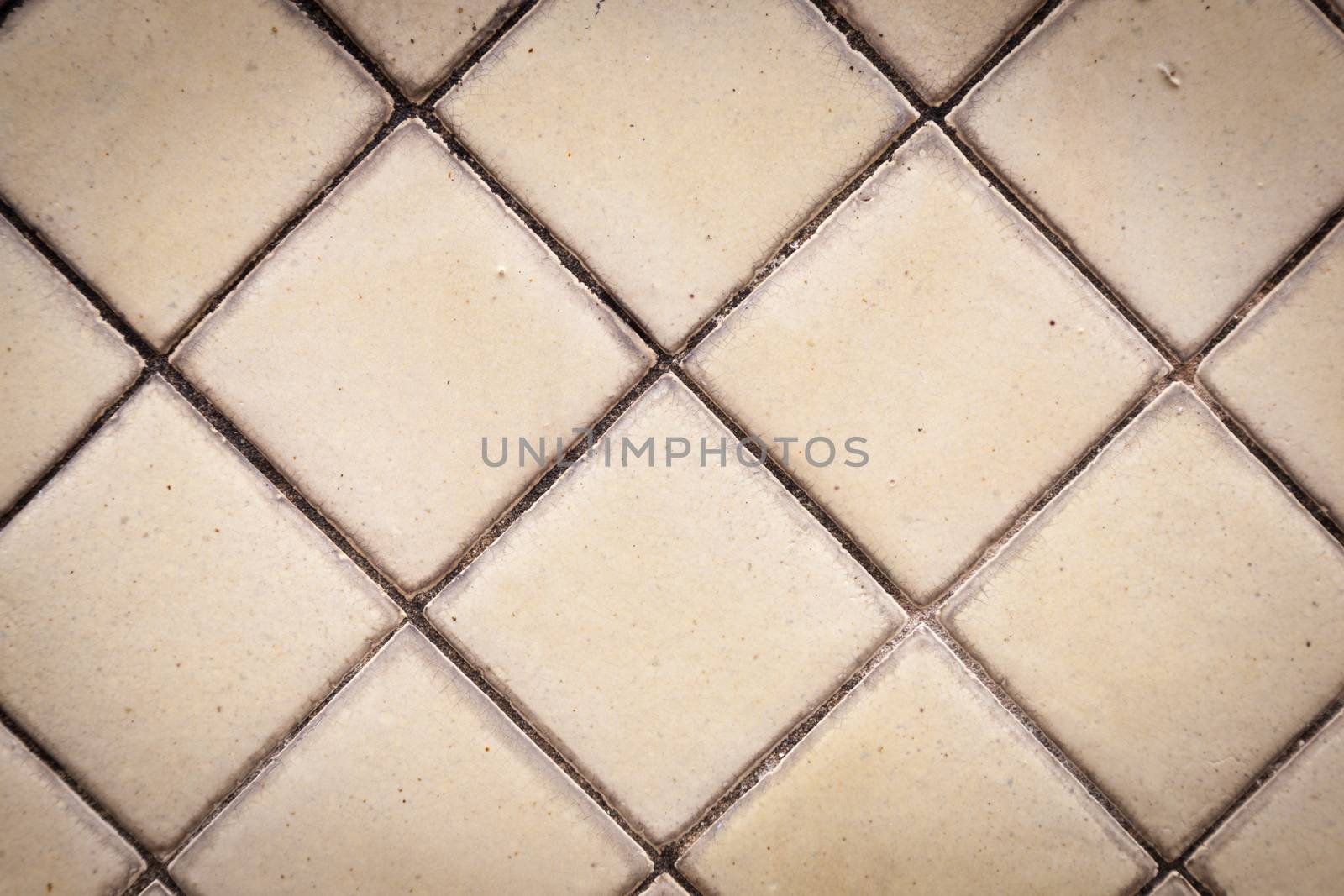 Tile squares. Which is on the back wall. There are stains on each groove between the sheets.