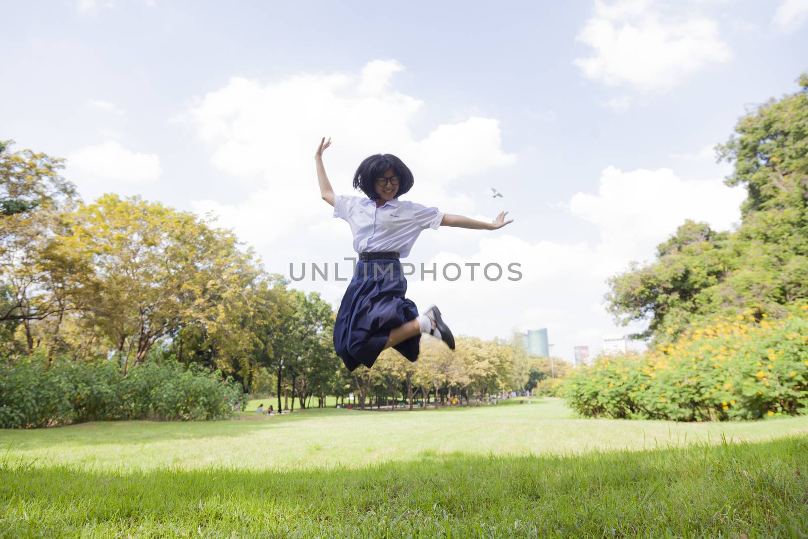 girl jumping Happy and fun.On grass in park