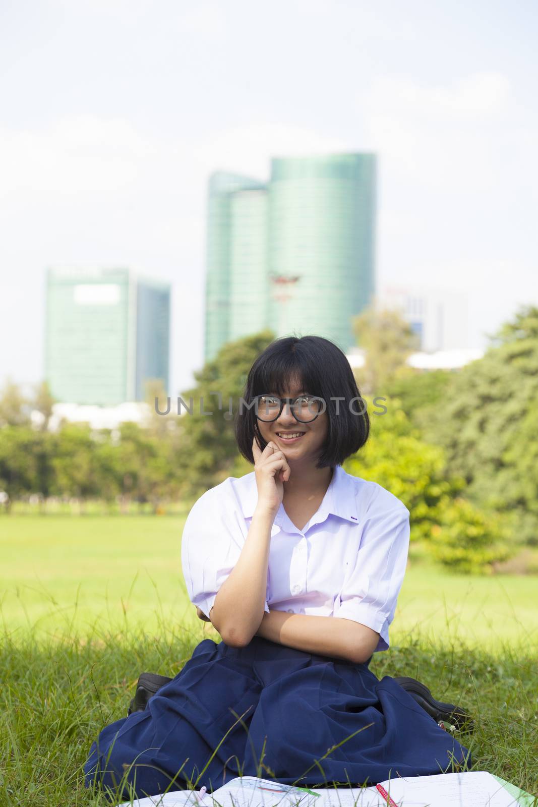 Girl was reading a happy on the grass in the park.girl happy and enjoy