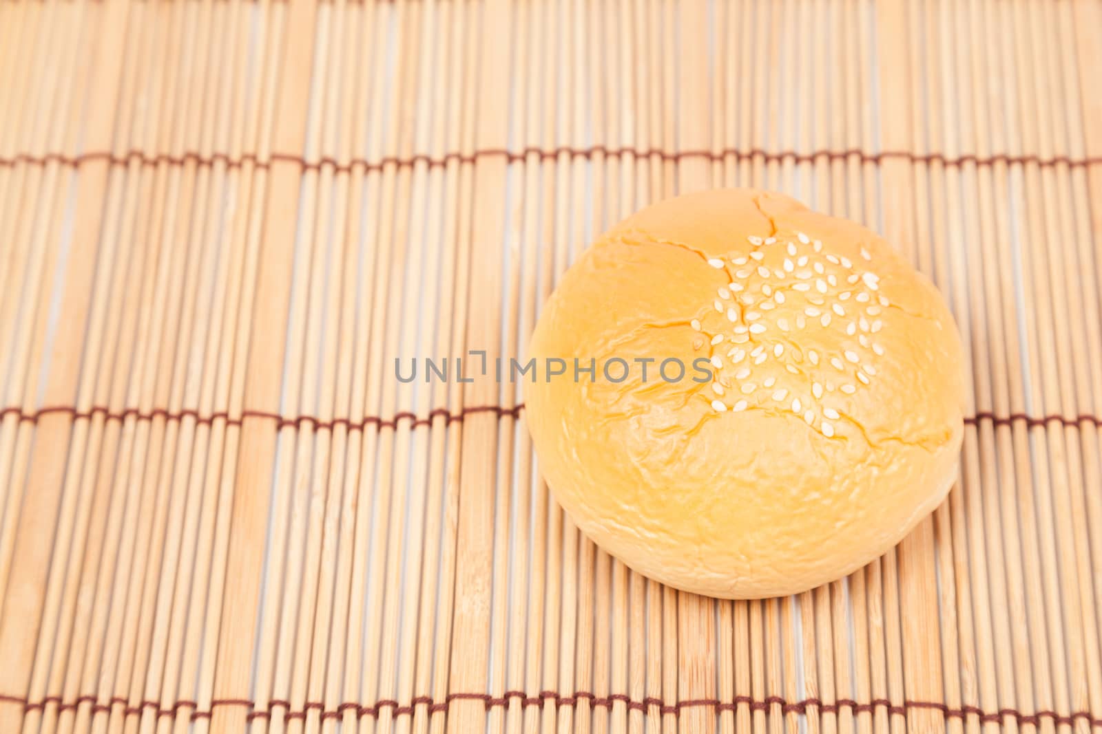 Bread sphere. A small white beans on top of bread. Placed on wood