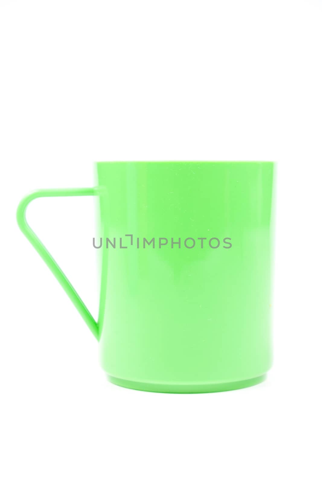 Green plastic glass. Isolated on white background. Taken in the studio