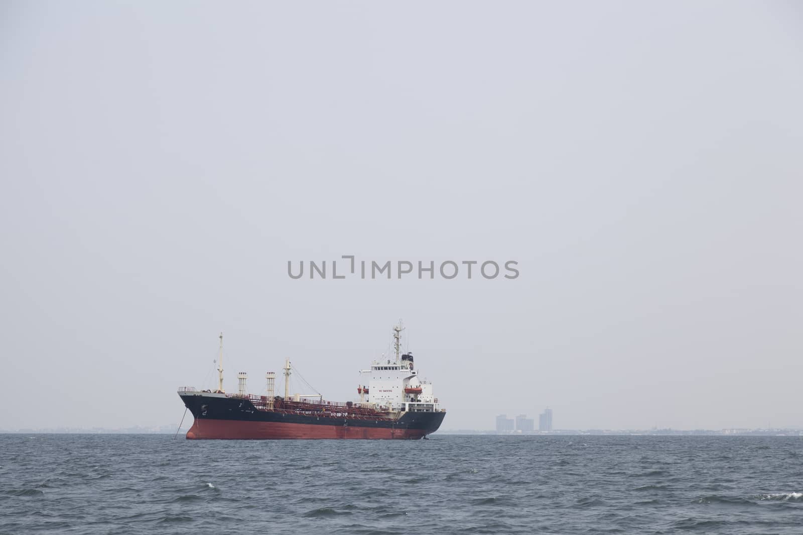 Large cargo ship Boats moored in the sea to make sense compared to the coast.