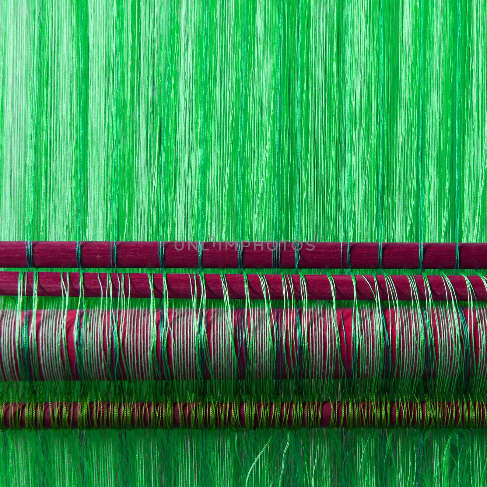 Handmade silk textile industry, silk scarf on a old machine (Vietnam), green