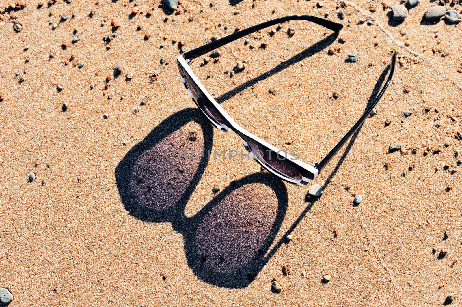 Reflection from plastic sunglasses in the sand