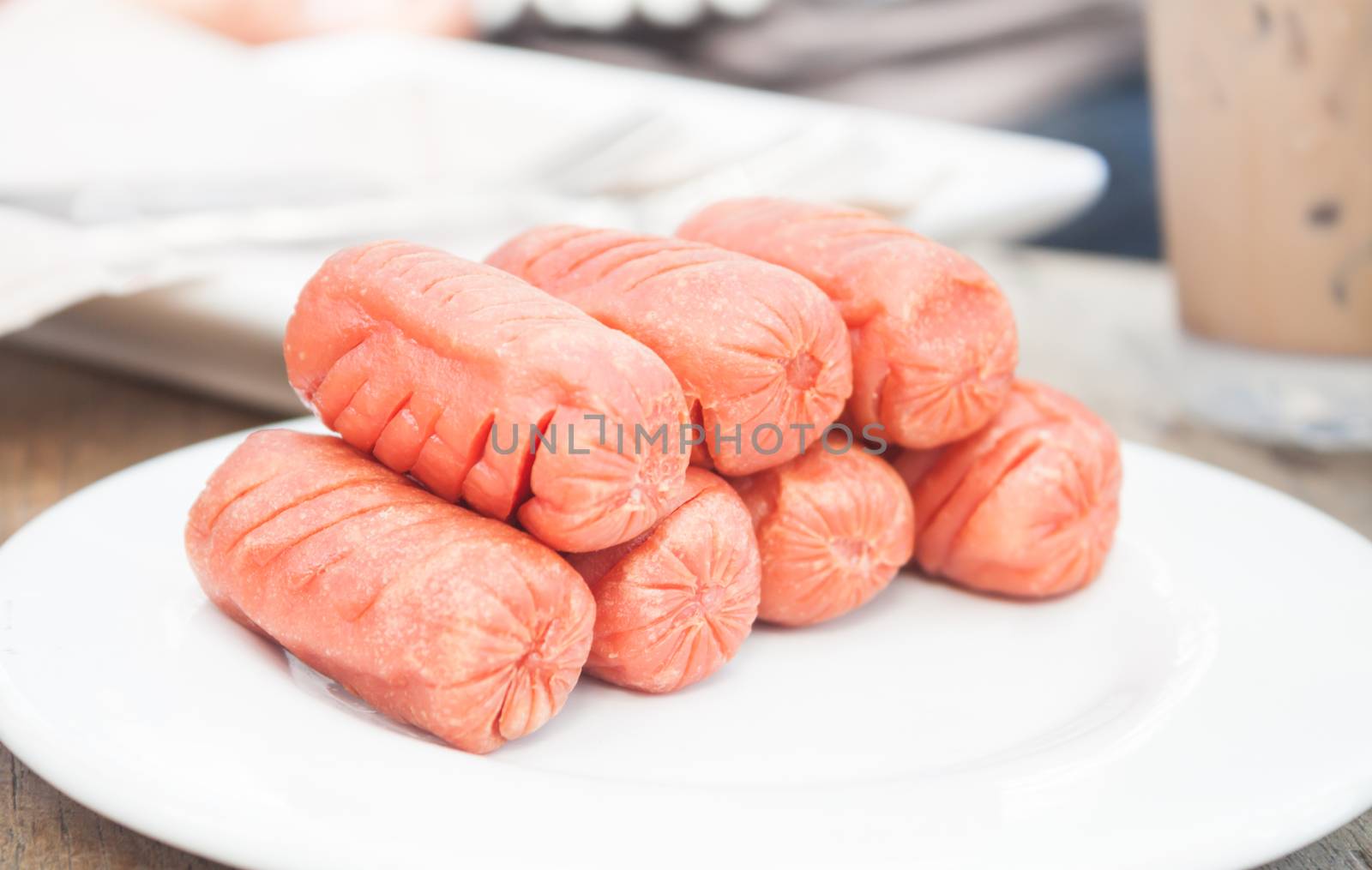 Fried sausages on white plate, stock photo