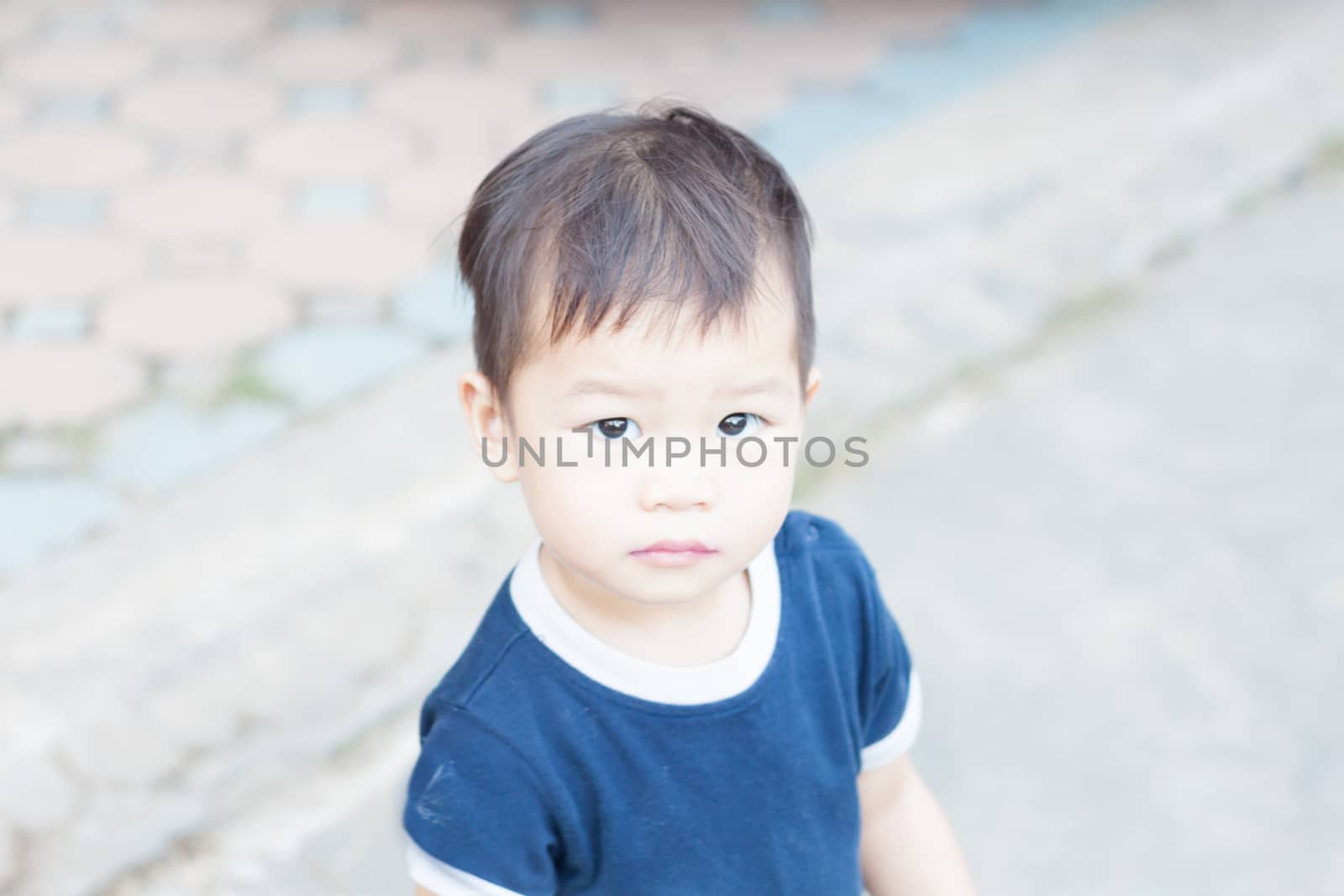 Little asian boy looking at camera  by punsayaporn