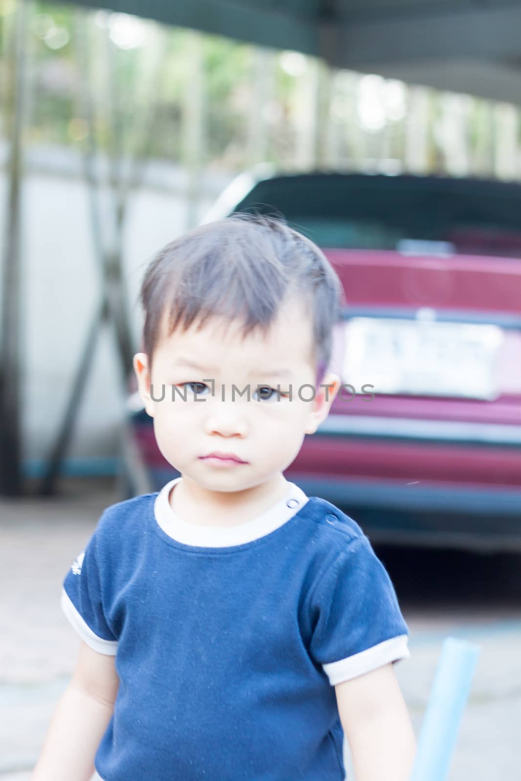 Little asian boy looking at camera  by punsayaporn