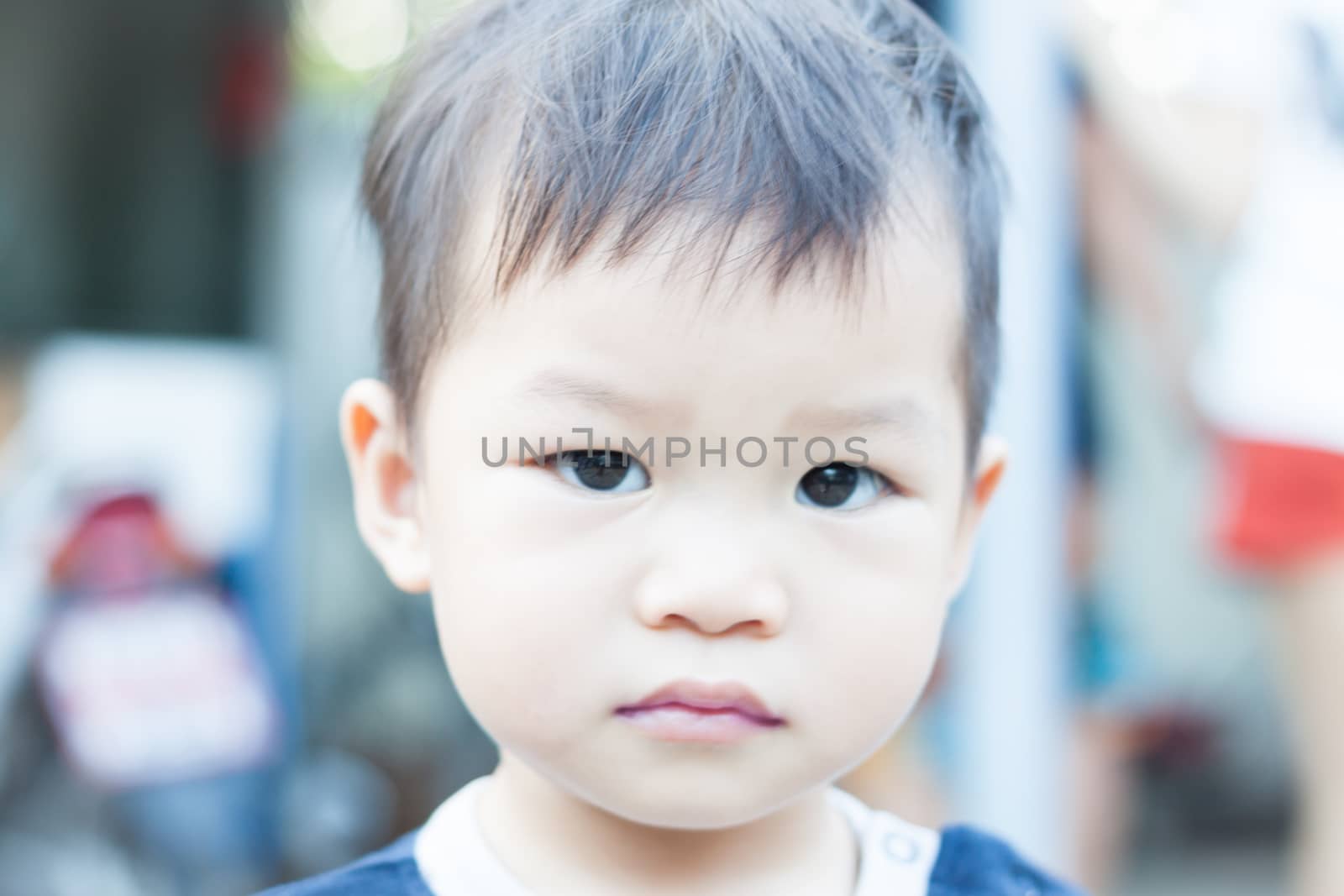 Little asian boy looking at camera  by punsayaporn