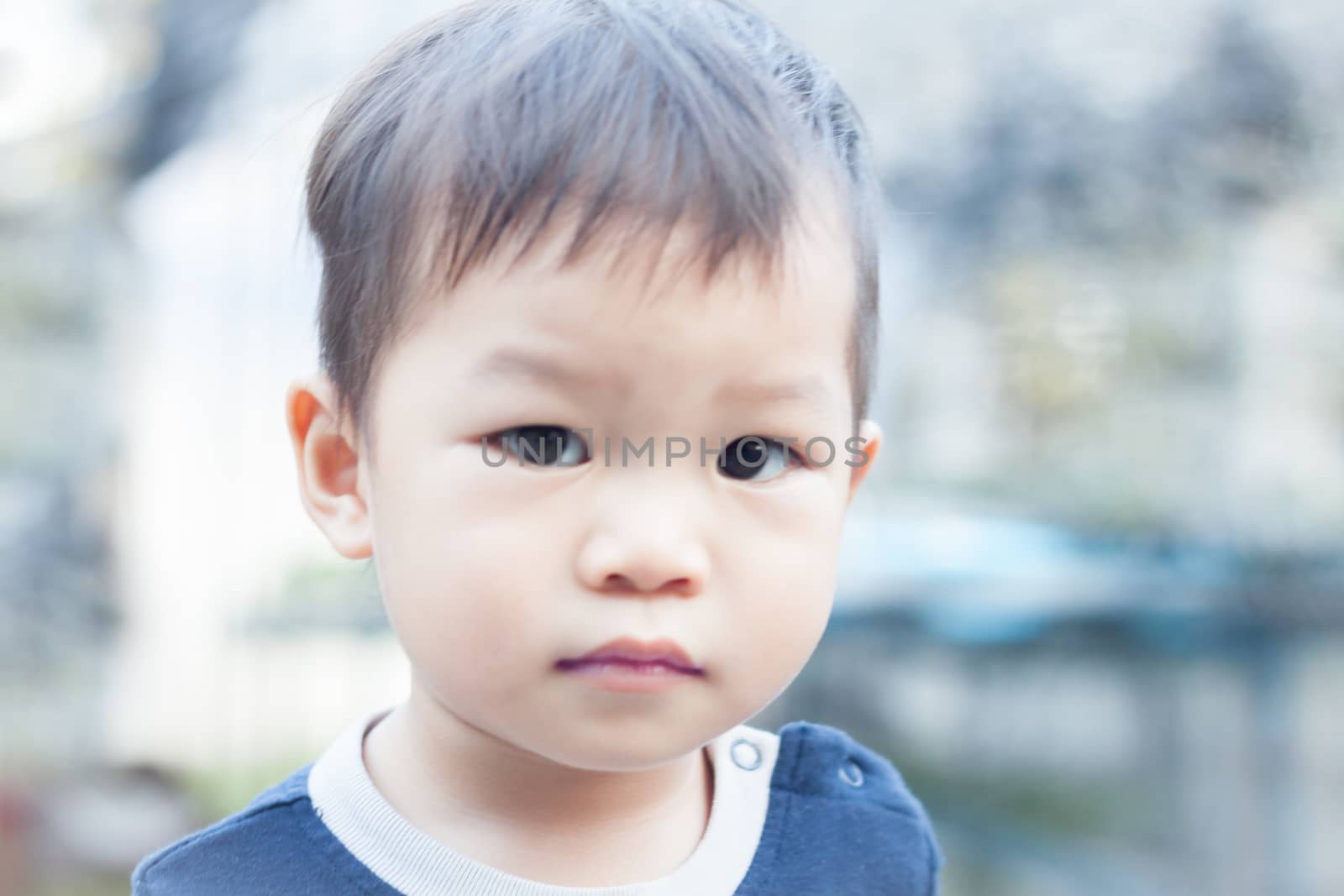 Little asian boy looking at camera  by punsayaporn