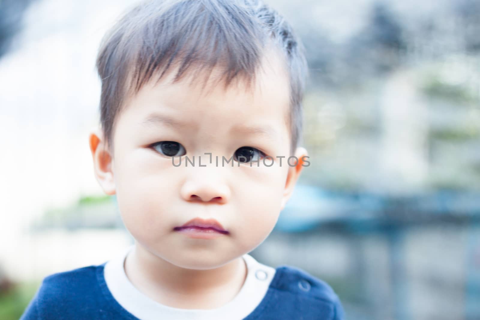 Little asian boy looking at camera , stock photo