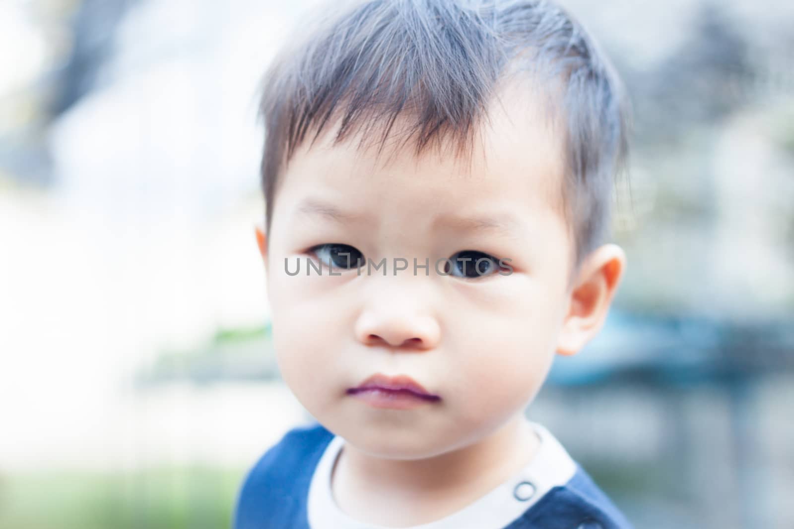 Little asian boy looking at camera , stock photo