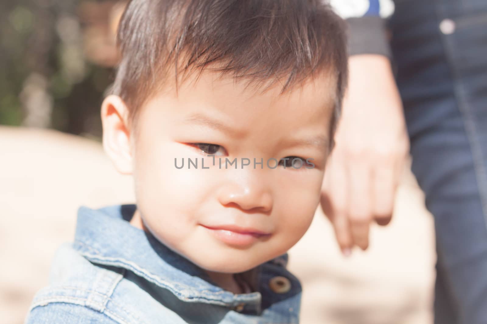 Little asian boy looking at camera  by punsayaporn