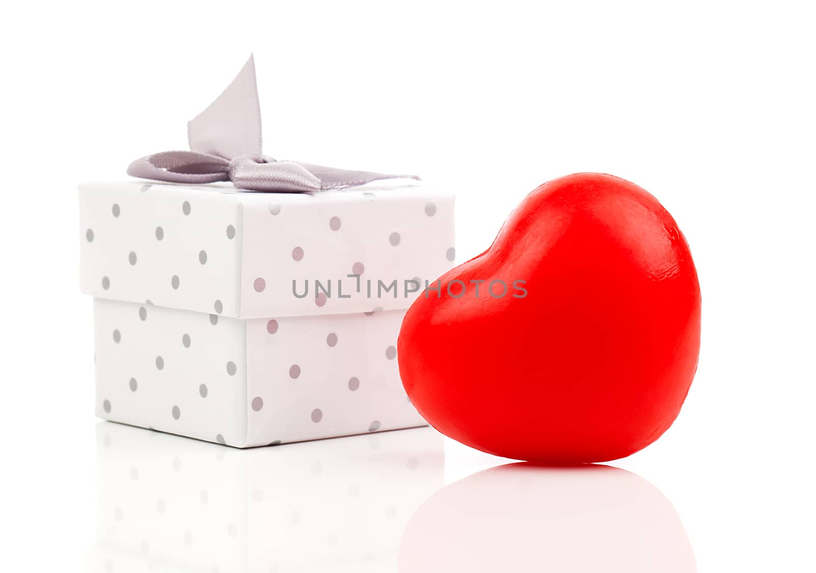 red heart with gift box, on white wooden background