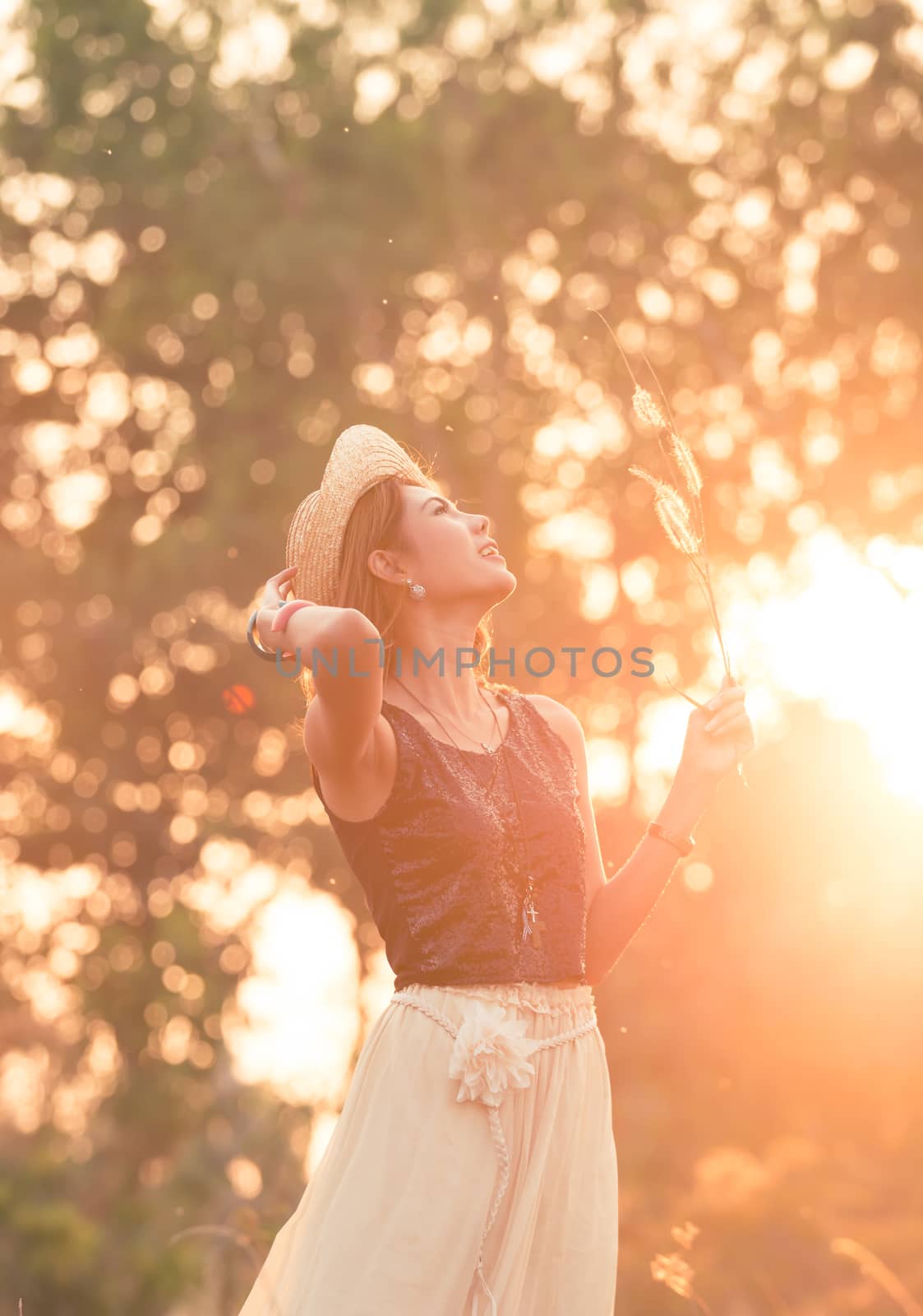 Beautiful Model girl on the Field in Sunset. Toned in warm colors