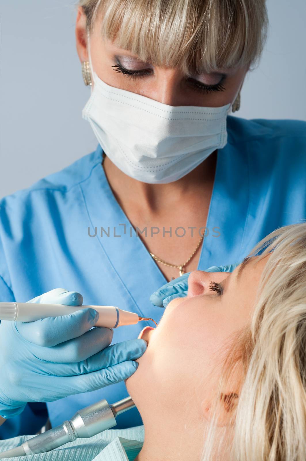 dentist at work with patient, dental exam and calcucus removal