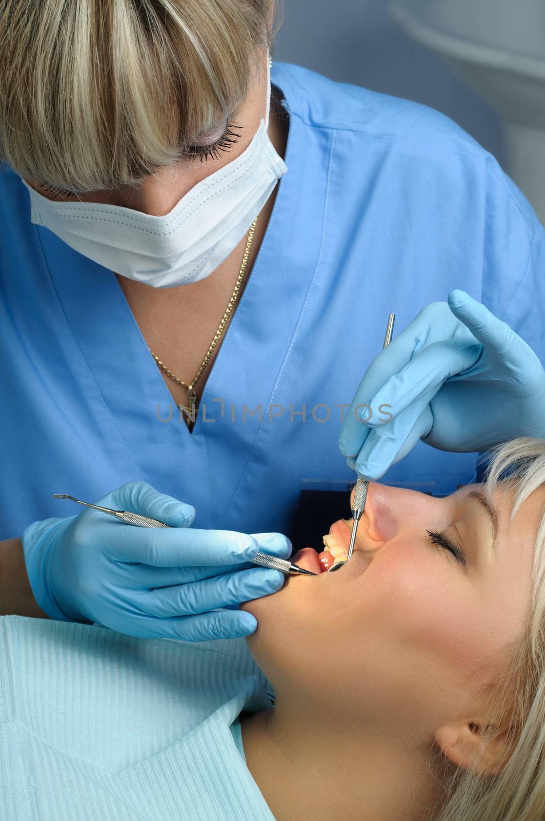dentist at work with patient, dental exam and calcucus removal