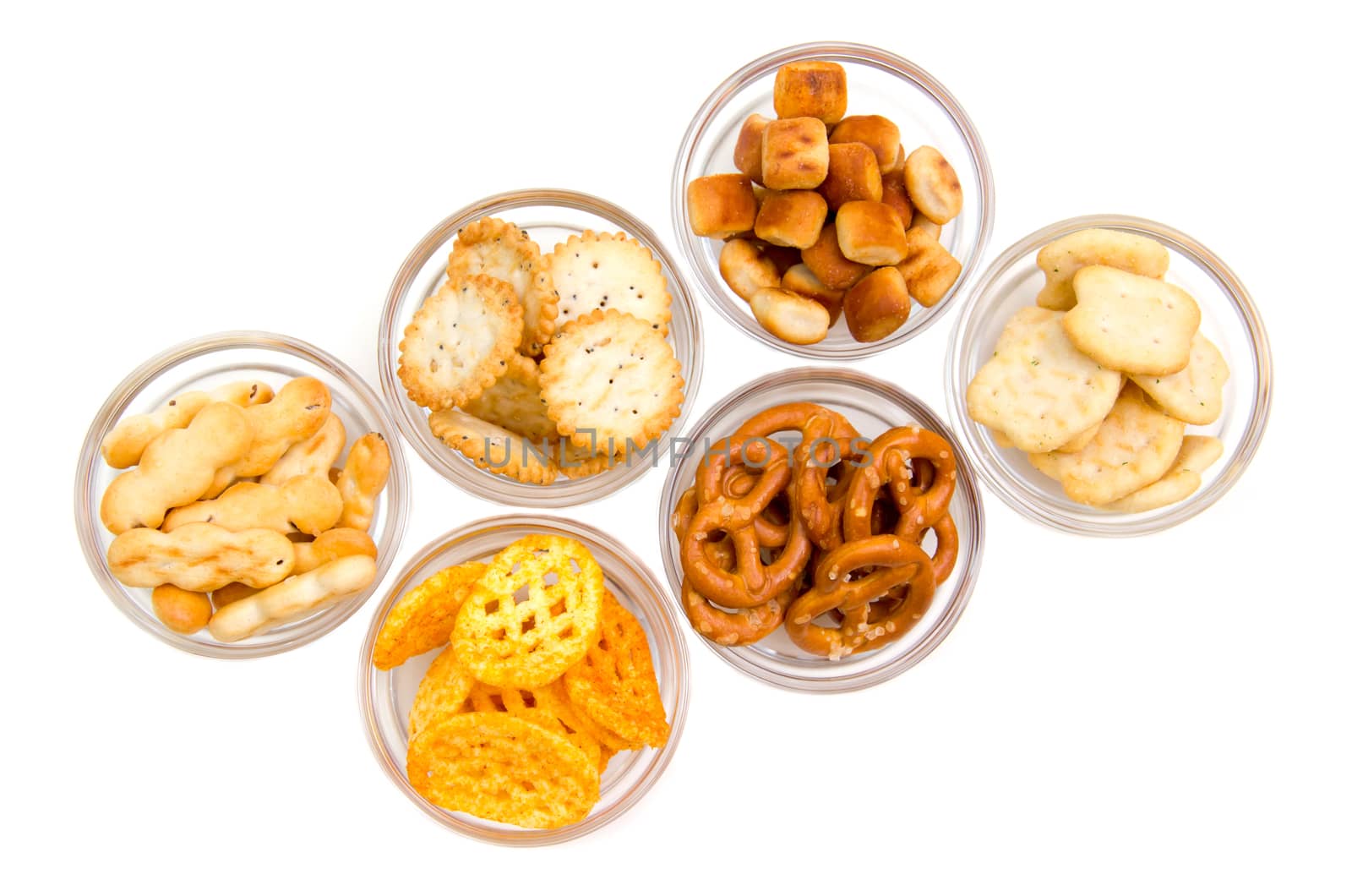Pretzels on glass bowls on white background viewed from above