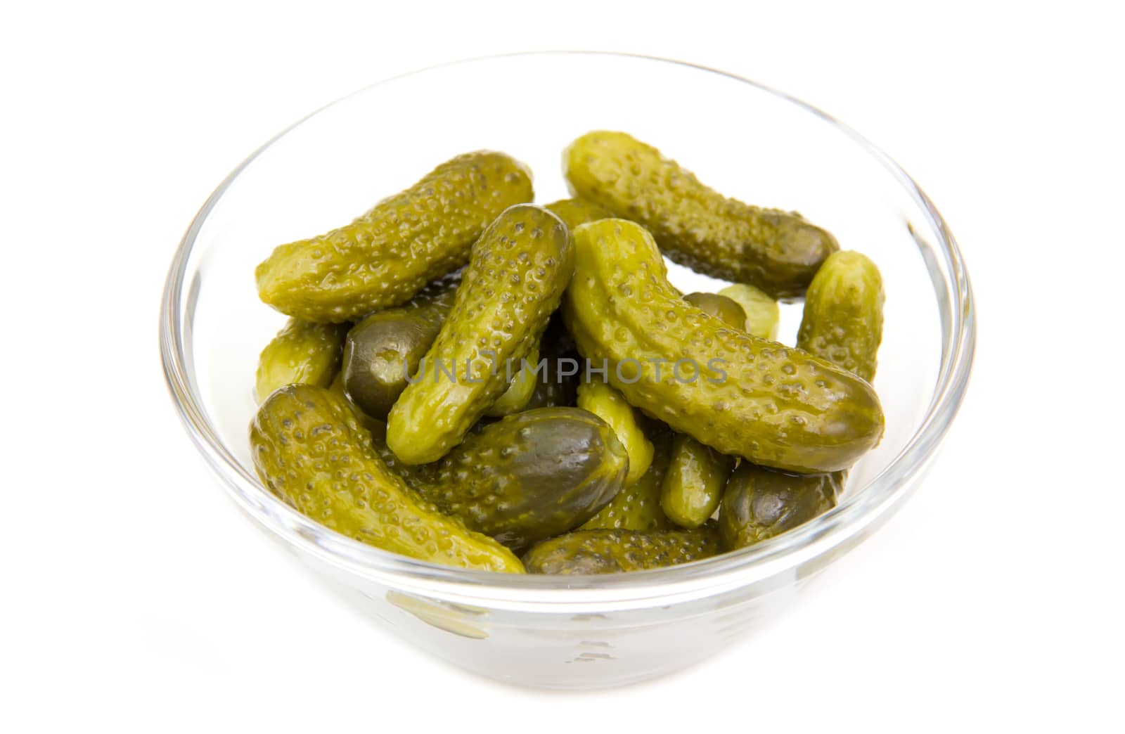 Pickled cucumbers on glass bowl on white background