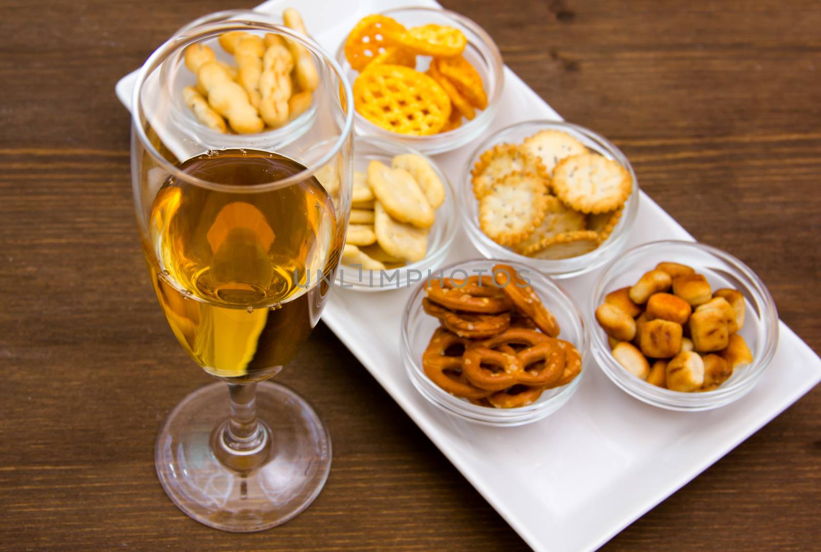 Flute with aperitif and pretzels by spafra