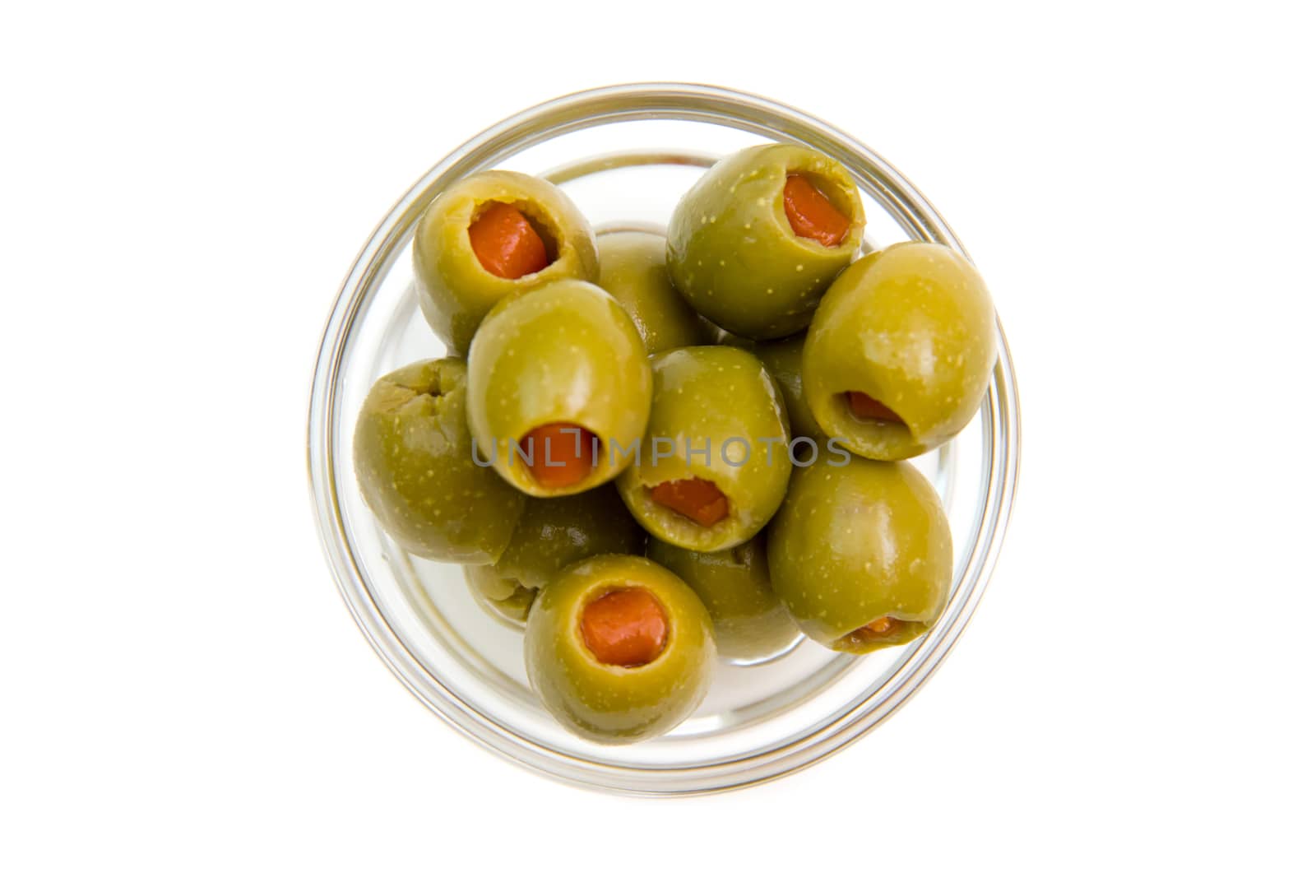 Stuffed olives on bowl on white background viewed from above