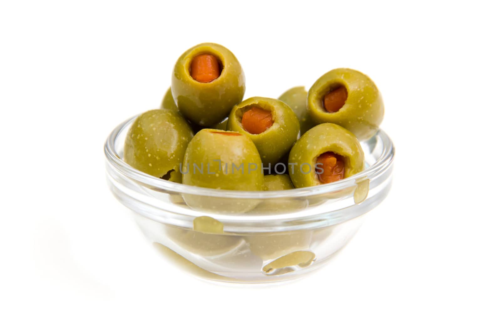 Stuffed olives on bowl on white background