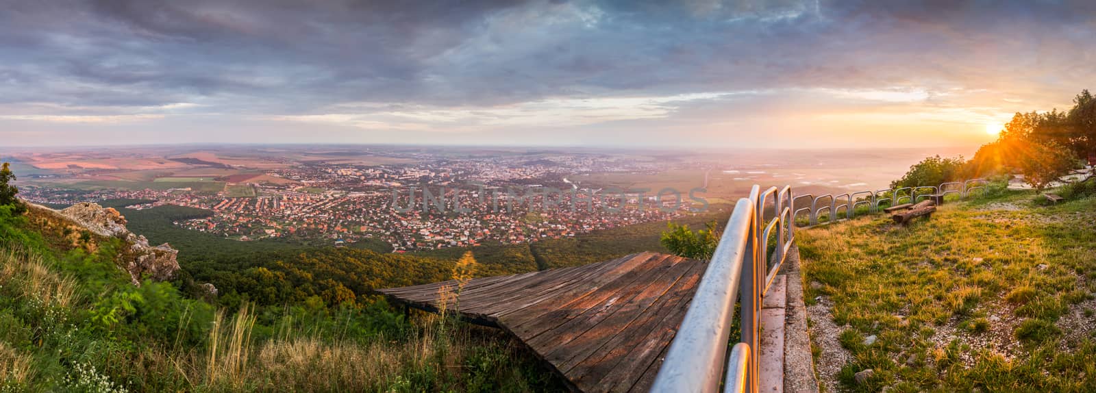 City of Nitra from Above at Sunset with Plants and Railings in Foreground as Seen from Zobor Mountain