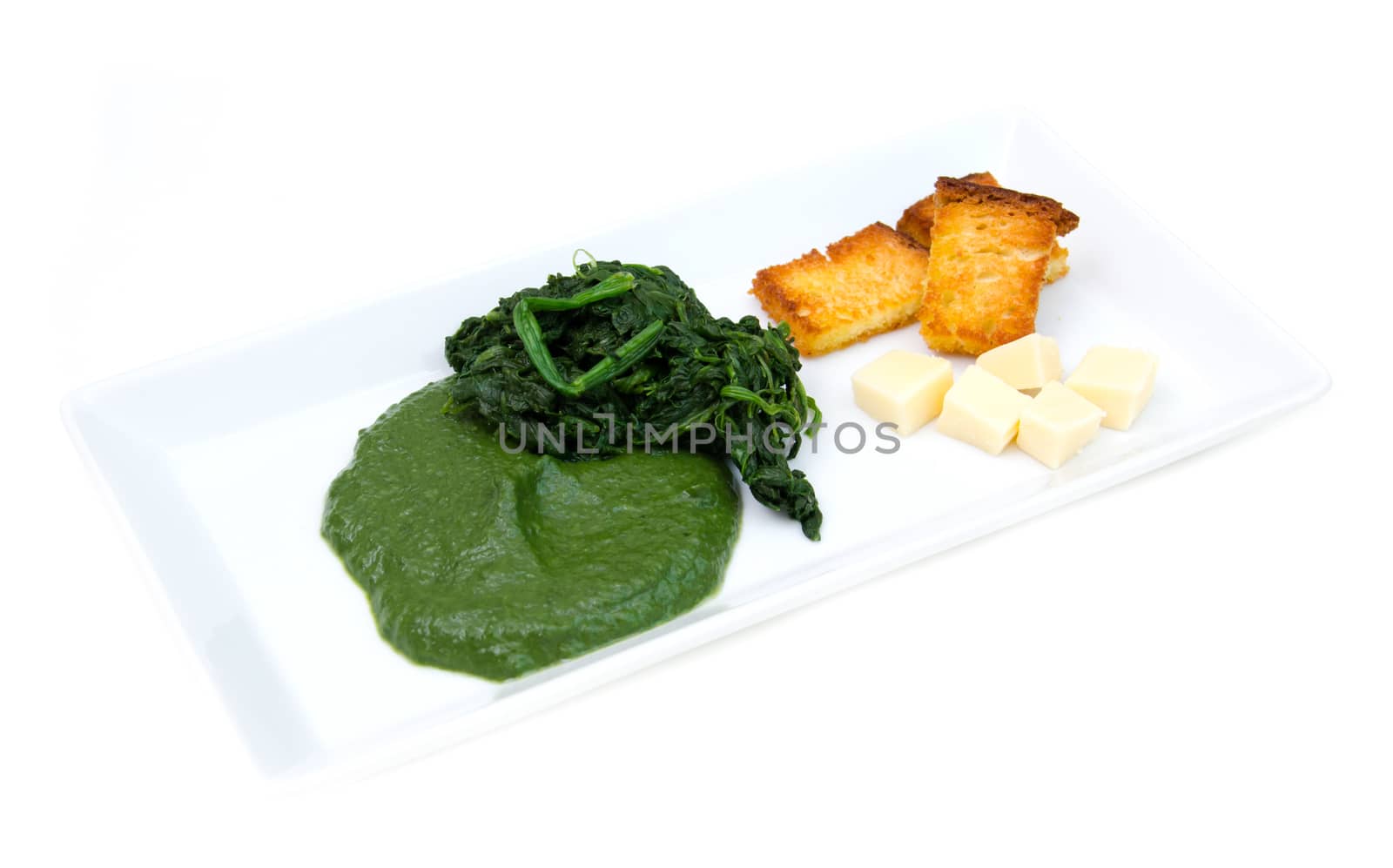 Tray with creamed spinach and croutons on a white background