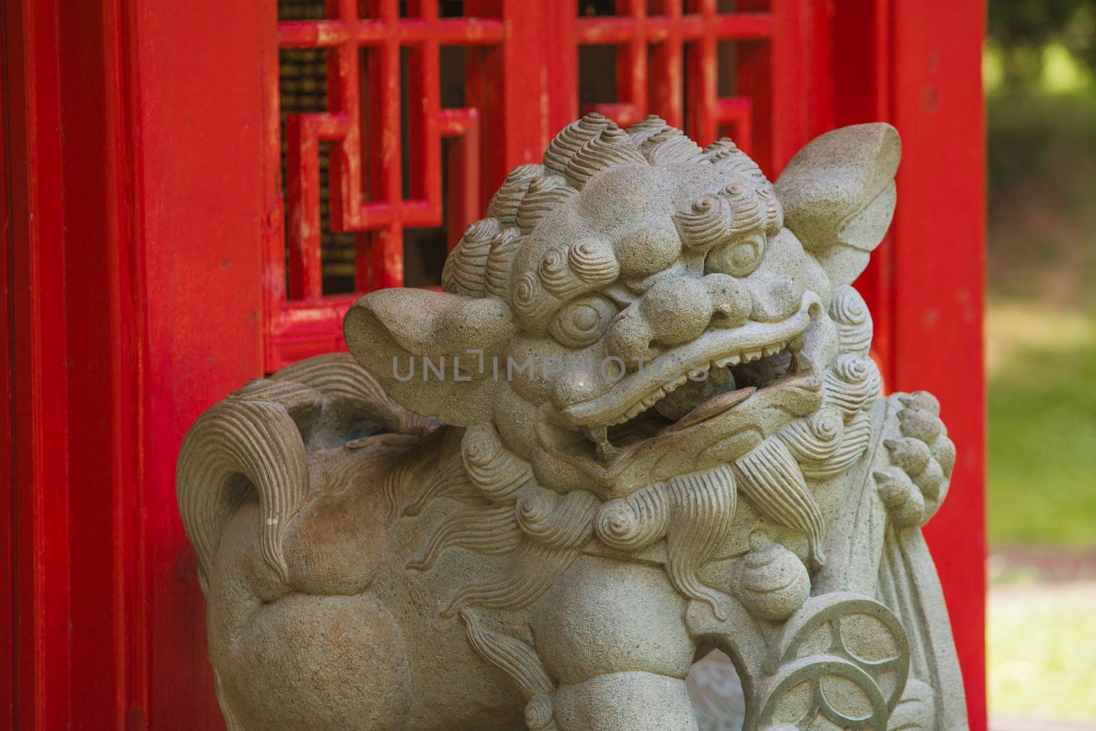 Chinese Guardian Lion in Front of Red Structure