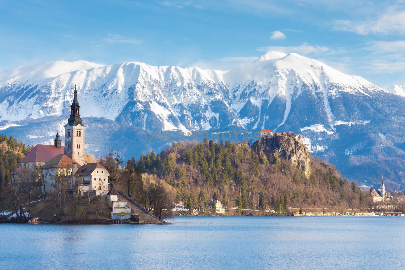 Panoramic view of Julian Alps, Lake Bled with St. Marys Church of the Assumption on the small island; Bled, Slovenia, Europe. 