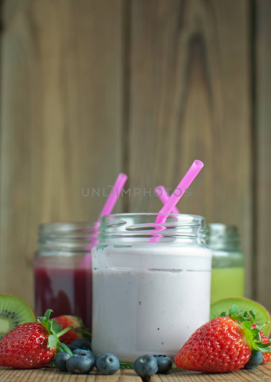 Three different flavoured smoothies in jars with space for text
