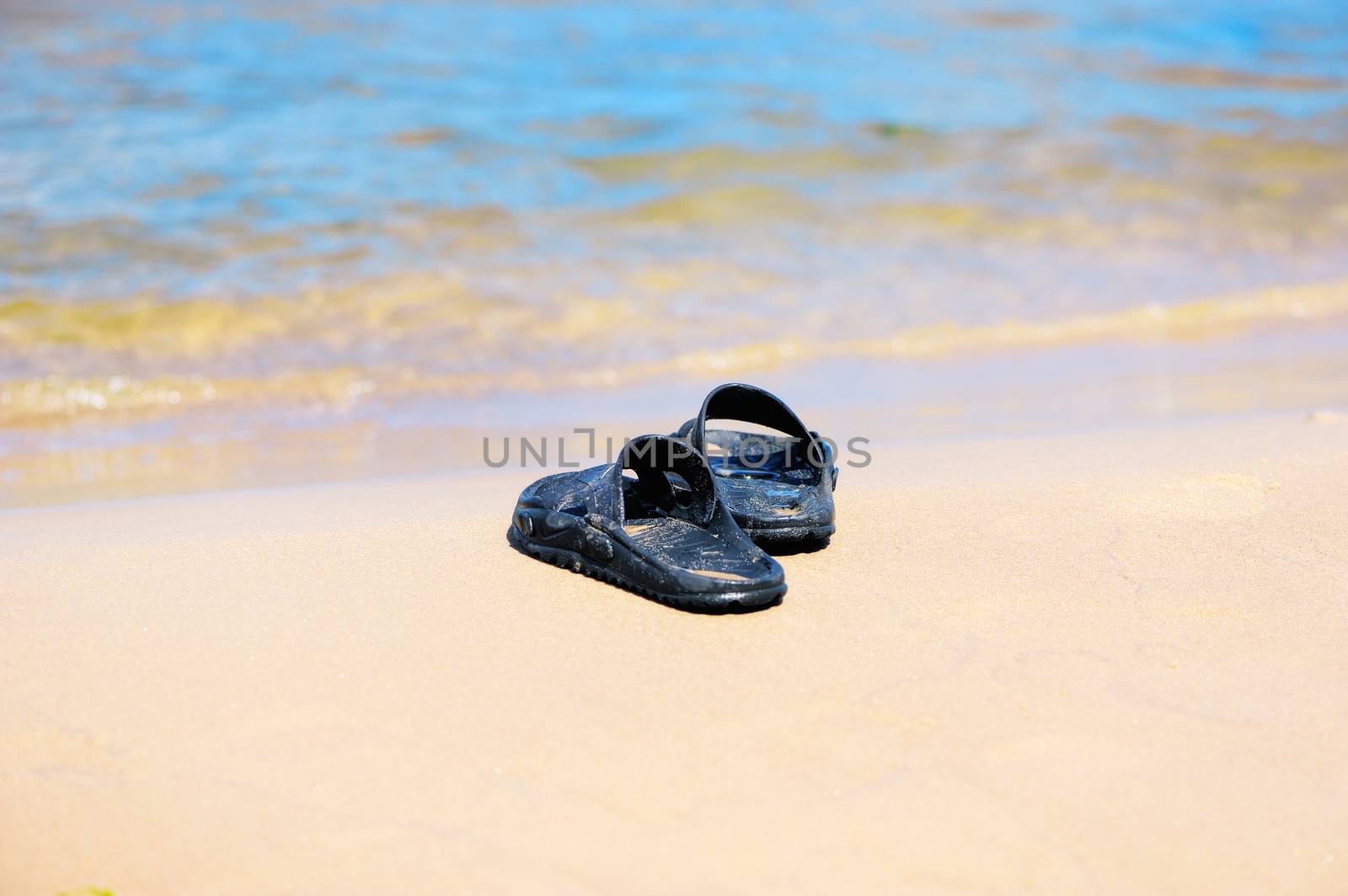 Rubber sandals on the sandy beach