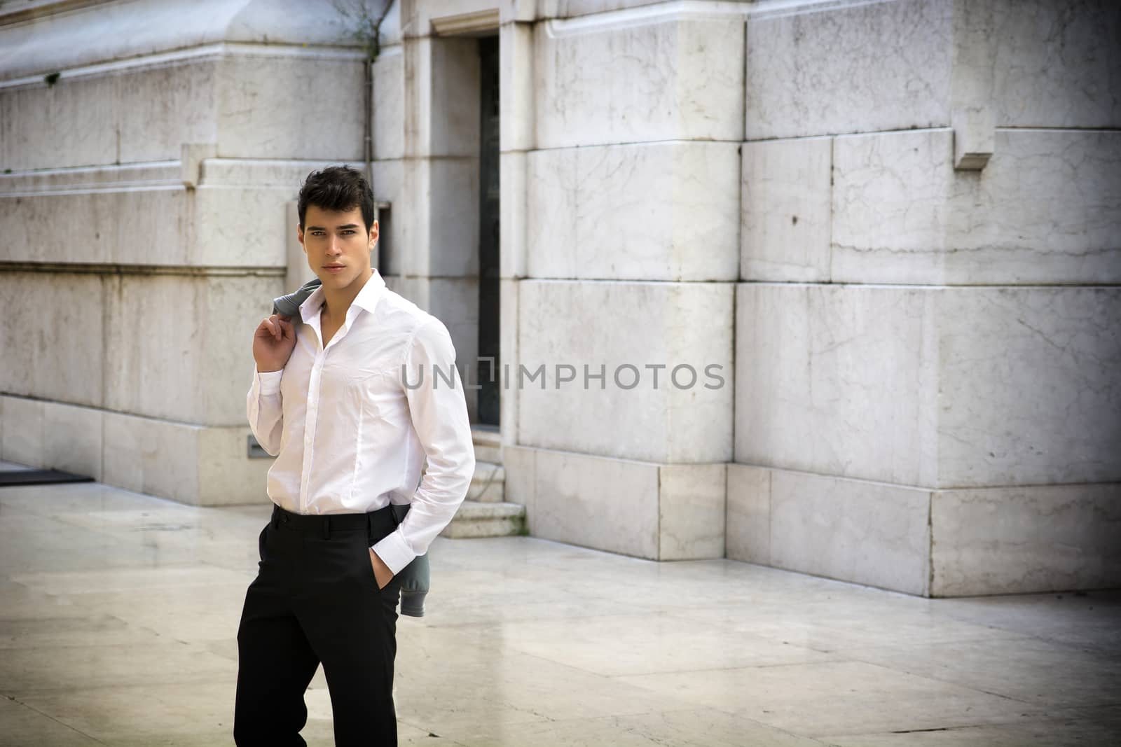 Elegant young businessman outdoor, marble wall and ground by artofphoto