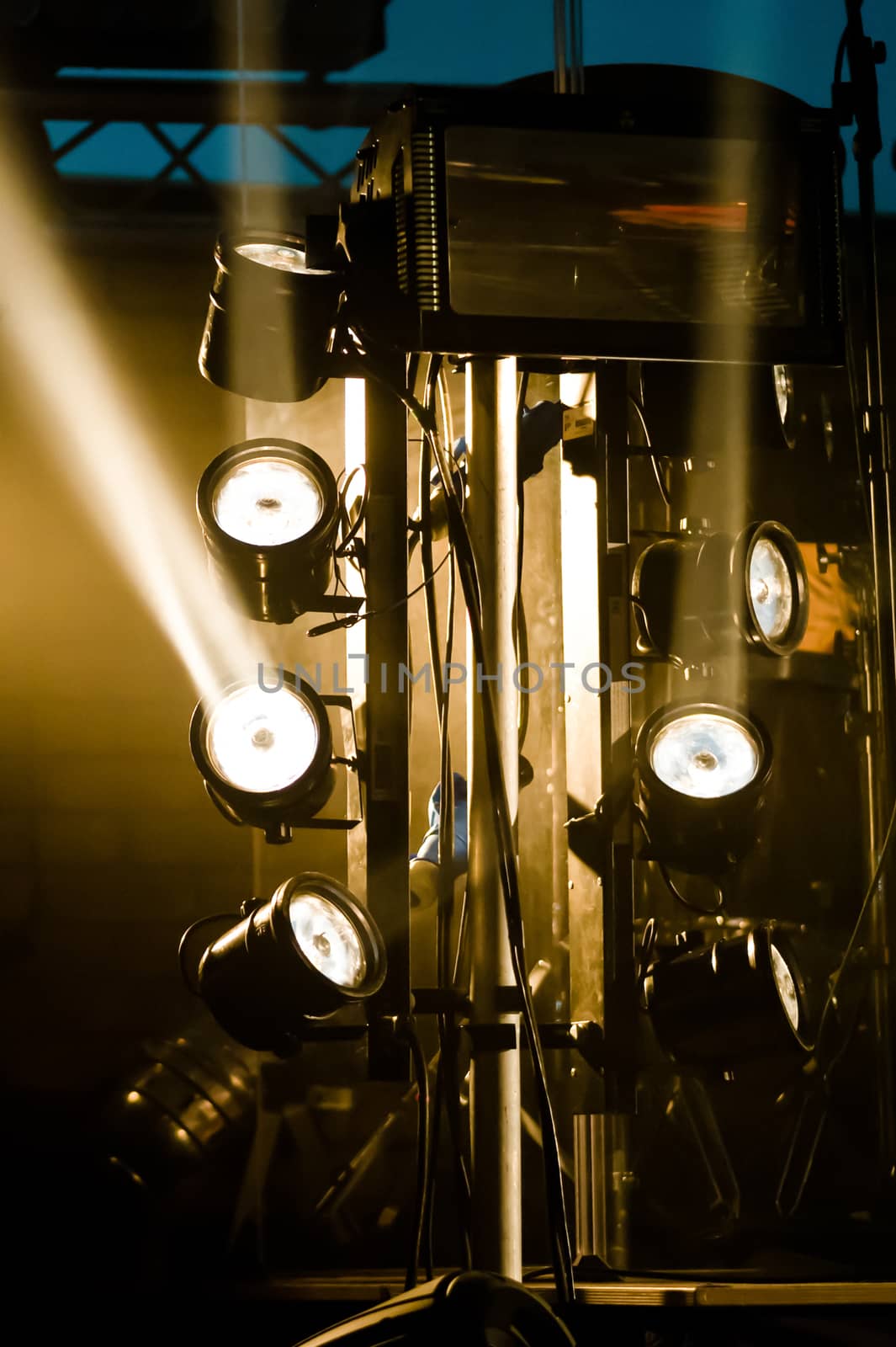 multiple spotlights on a stage lighting rig
