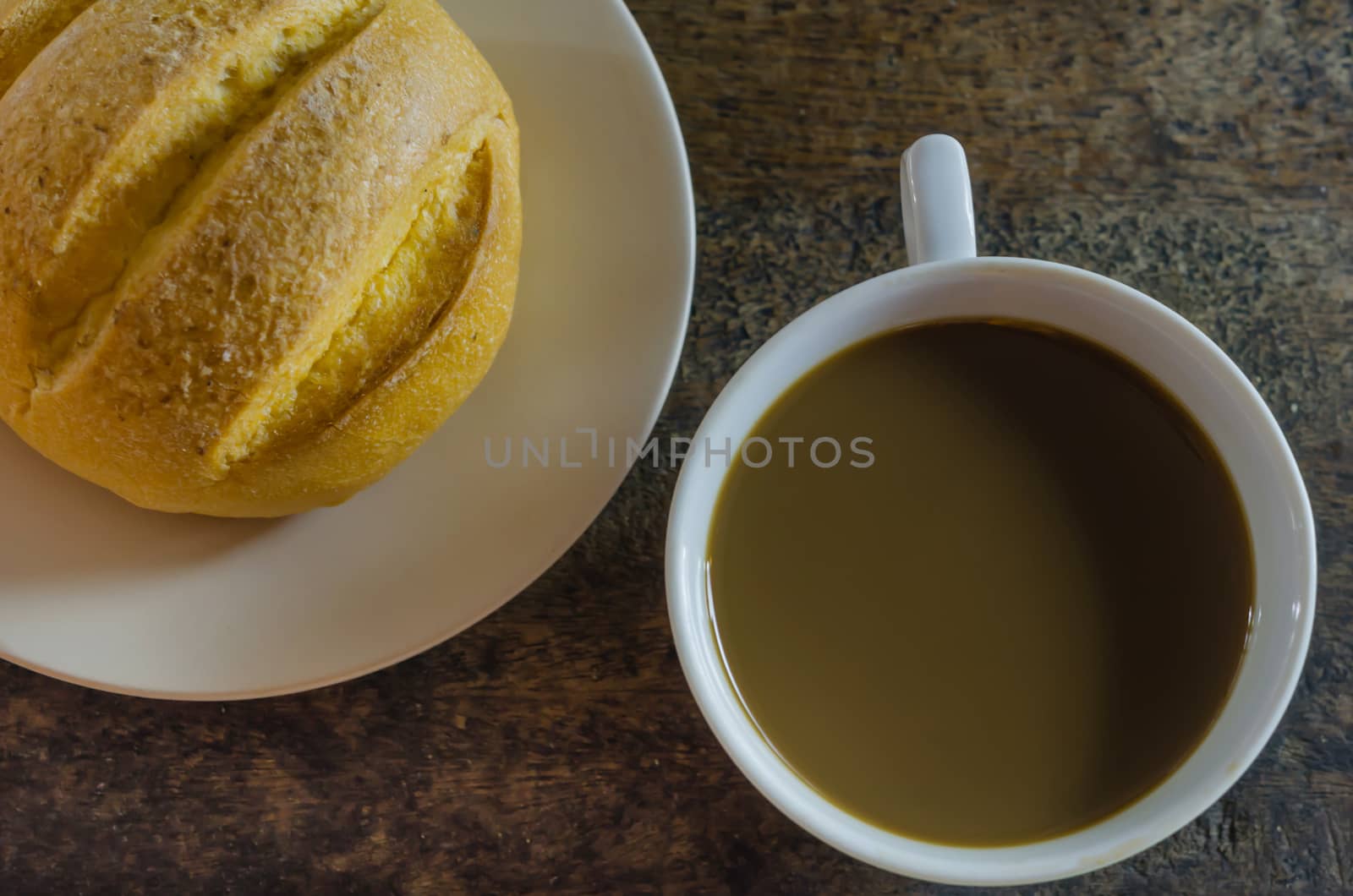 hot coffee with fresh bread on wooden  background  ,  still life