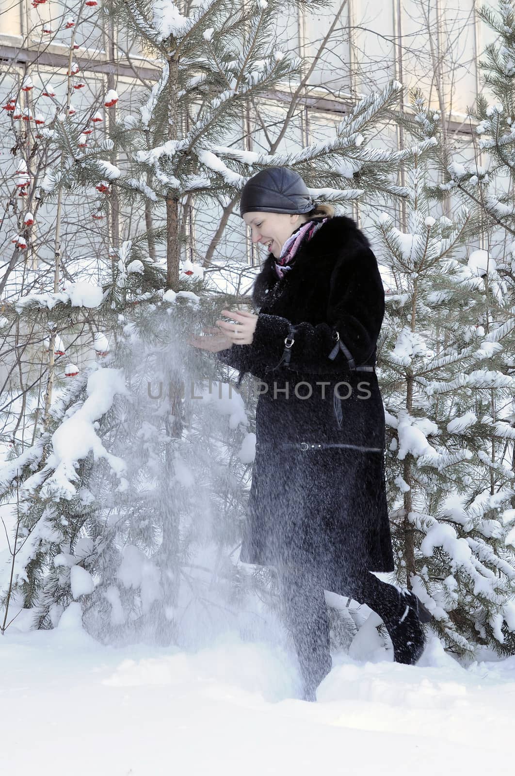 The cheerful woman in a black fur coat costs at snow-covered pin by veronka72