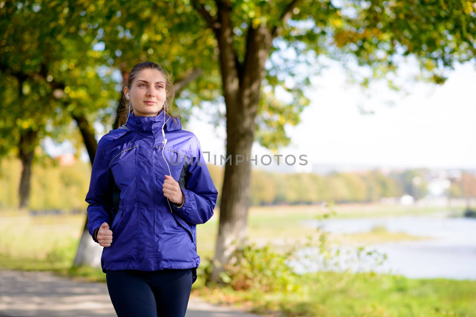 Young Beautiful Woman Running in the Park by maxpro