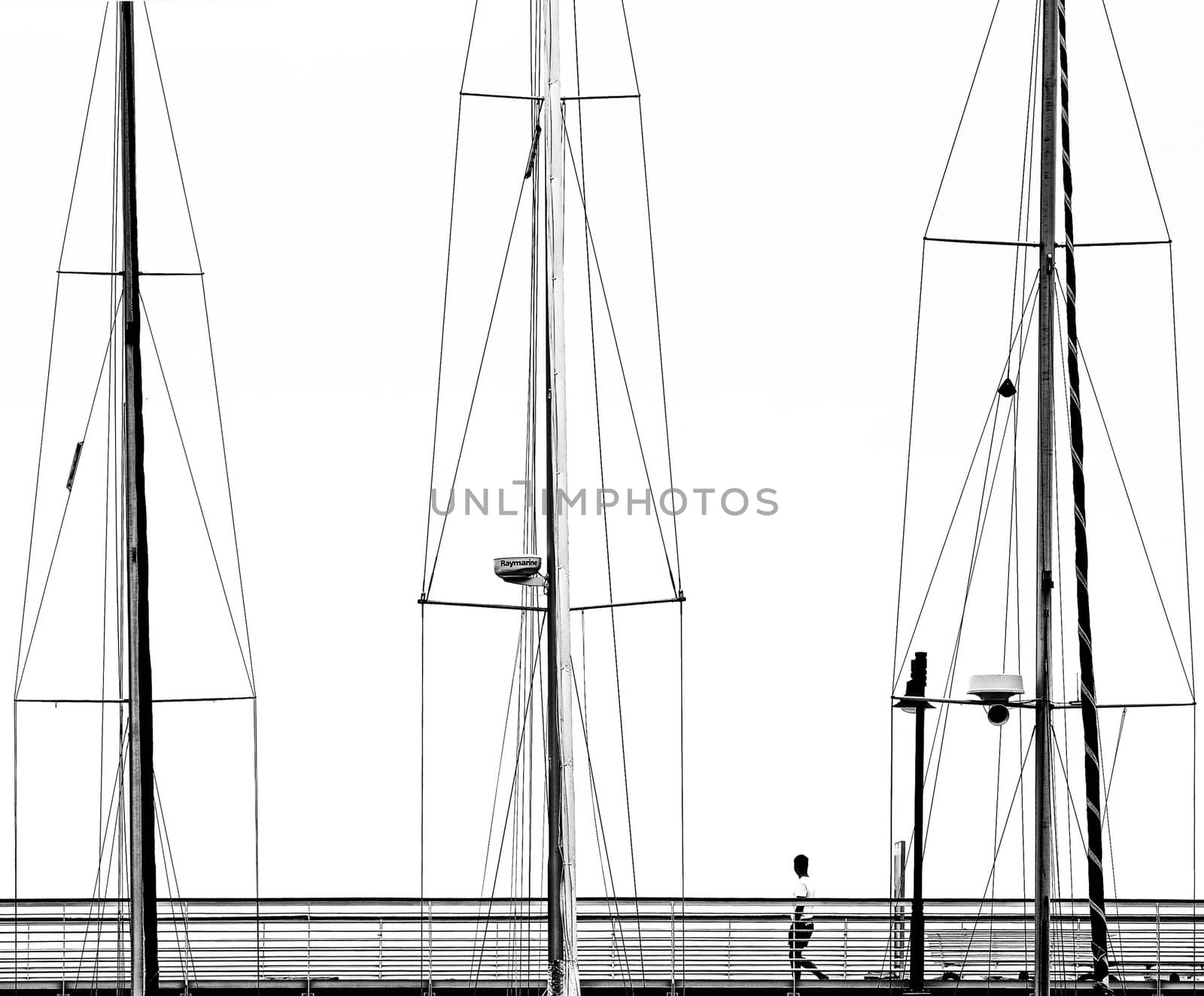 A man over a pier, trapped into sailboats